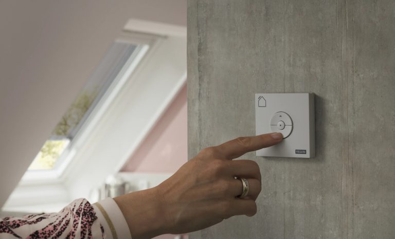 Mano che preme il comando a parete VELUX