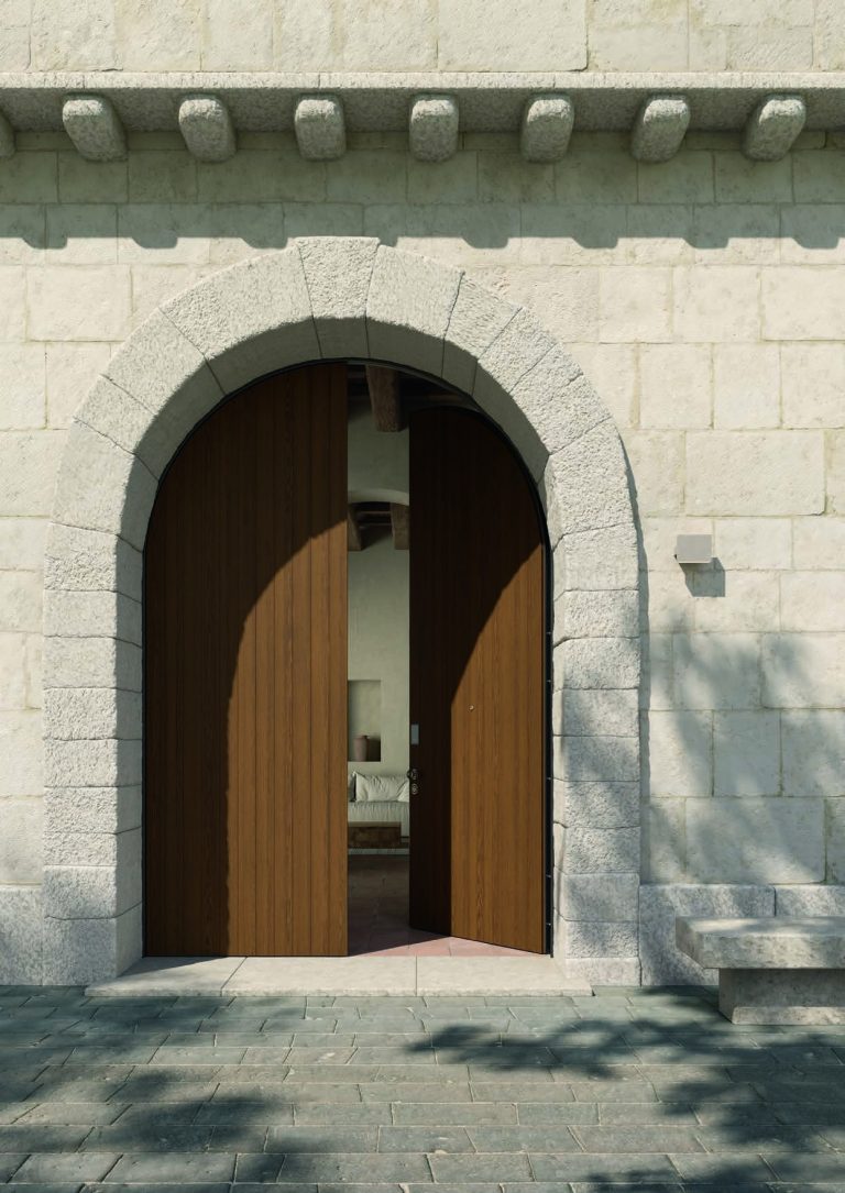 Porta blindata a due ante in legno aperta sotto un arco in pietra (verticale)