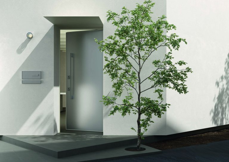 Ingresso moderno bianco con porta blindata grigia a maniglione, albero e pensilina